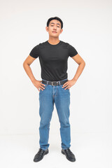 A proud young Asian man standing tall with his hands on his waist. Isolated on a white background.