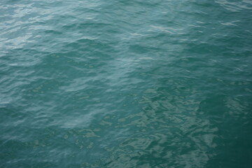 Calm turquoise sea surface in Nessebar, Bulgaria. Gentle waves and sunlight reflections create a peaceful marine background — perfect texture for summer, travel, and nature concepts.