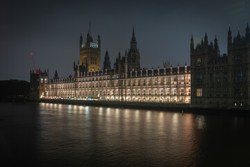 The illuminated Palace of Westminster beside the River Thames, London, at night