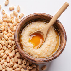 Lotus Seed Dessert with Spoon: A wooden bowl filled with a creamy, delicate lotus seed dessert is shown from an overhead perspective. A wooden spoon rests, poised to scoop a spoonful from the dessert
