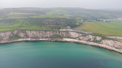 Aerial view on Cliffs and coast of Atlantic Ocean, Carrick a Rede Rope Bridge in Ballintoy, Northern Ireland. 