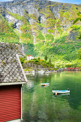 Charming Flam village with traditional houses and boats on the fjord
