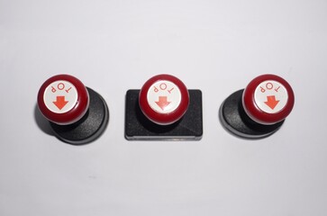Three red rubber stamps with black base isolated on white background, office equipment for documents, official approval, and administrative tasks.