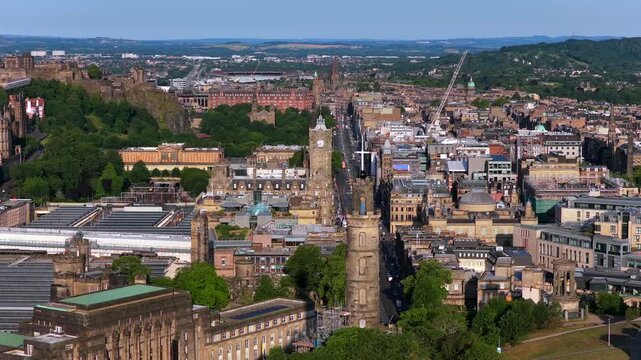 Aerial video from Calton Hill showcasing Edinburgh cityscape with Nelson Monument centered, looking toward the Castle and Princes Street.