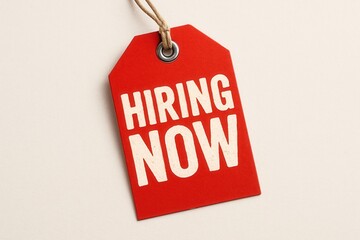 Red tag with the words "HIRING NOW" in bold white letters, creating a clear and urgent call for job applications and employment opportunities.