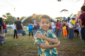 Happy little boy enjoy outdoor theme park festival