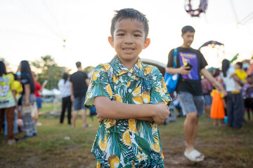 Happy little boy enjoy outdoor theme park festival