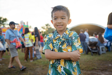 Happy little boy enjoy outdoor theme park festival