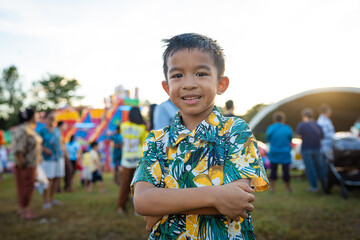 Happy little boy enjoy outdoor theme park festival