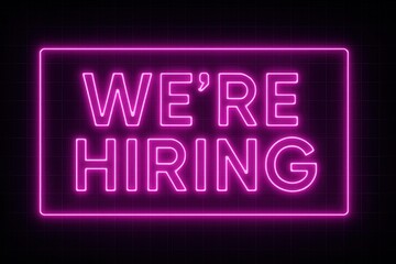 Neon pink "We're Hiring" sign on a dark background, featuring bold, glowing letters to attract attention for job recruitment purposes.