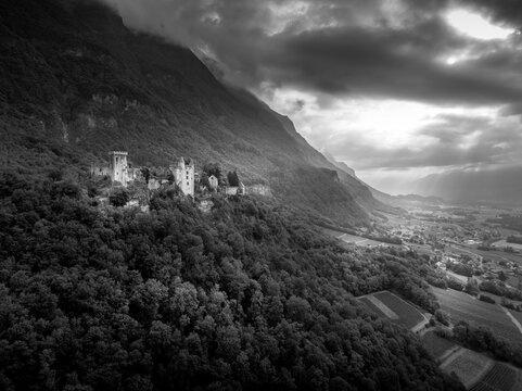 Rising defiantly from its rocky perch above the Combe de Savoie, Miolans Castle is a striking testament to medieval power in the French Alps black and white