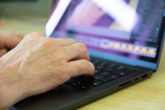 Close image of a man working with laptop