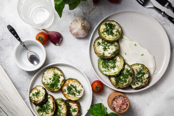 Appetizing Fried zucchini with garlic sauce in a white plate