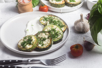 Appetizing Fried zucchini with garlic sauce in a white plate