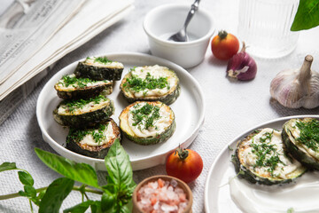 Appetizing Fried zucchini with garlic sauce in a white plate