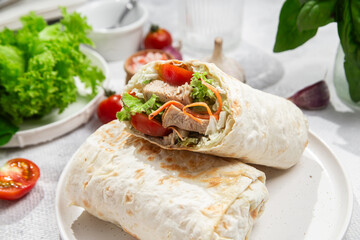 Appetizing Shawarma with chicken and fresh vegetables on a light background
