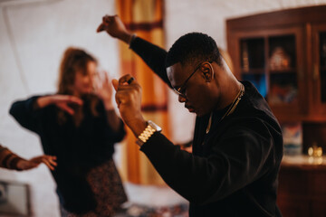 Young people dancing together in a casual indoor environment, expressing joy and energy.