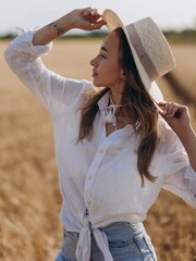 Close-up view to young Woman in a Wheat Field on a Sunny Summer Day