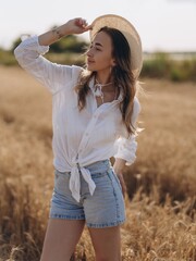 Close-up view to young Woman in a Wheat Field on a Sunny Summer Day
