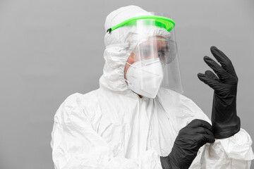 Healthcare worker prepares protective gear during covid pandemic response efforts in a clinical setting