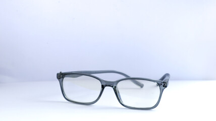 Close-up of elegant plastic frame glasses on a clean white background, perfect for vision, reading, or accessory concepts.