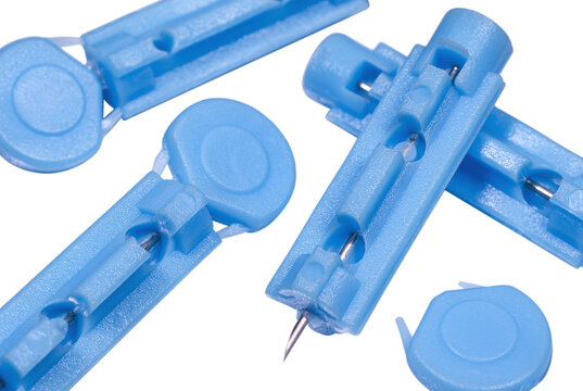 Blue disposable sterile lancets for blood draw close up
