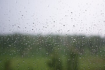 Raindrops on the window during a strong hurricane with wind in nature