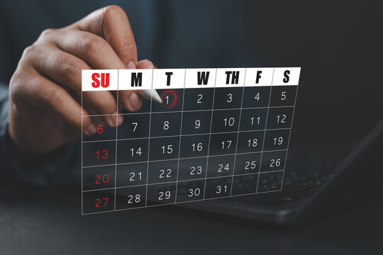 Businessman scheduling a digital calendar on laptop, highlighting the first of the month, symbolizing time management, appointment booking, smart scheduling system, event planning, productivity