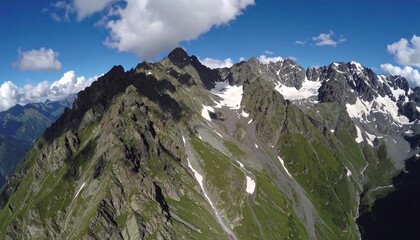 Mountain panorama under a partly cloudy sky