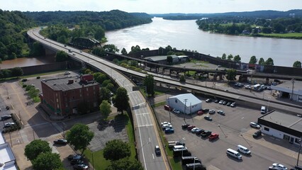 This aerial perspective captures the vibrant downtown Parkersburg, West Virginia, featuring the Ohio River and nearby historic structures on a sunny day.