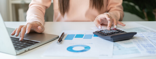 Deduction planning, debt asian young woman  hand using laptop computer, calculator calculating...