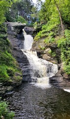 Lush greenery surrounds the cascading water of Raymondskill Falls near Milford, Pennsylvania, U.S