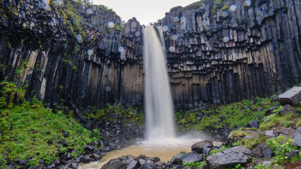 Stunning waterfall cascades down basalt columns at Svartifoss in Icelands Vatnajokull National Park
