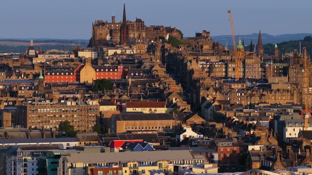 Aerial view of Edinburgh revealing the historic Royal Mile, Edinburgh Castle, and surrounding architecture at Sunrise