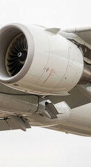 Close-up of airplane engine and wing, showcasing metallic, gray and white parts, illustrating power, technology, and air travel