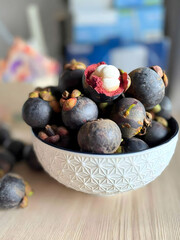 Close‑up of Ripe Mangosteens in White Patterned Bowl