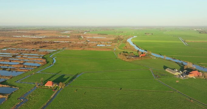 Aerial view of wetland and nature reserve Rottige Meente, next to vibrant green fields with farms, Weststellingwerf, Friesland, Netherlands.