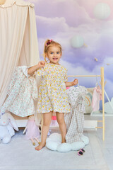 Smiling Toddler Girl in Dreamy Kids Room choosing the dresses