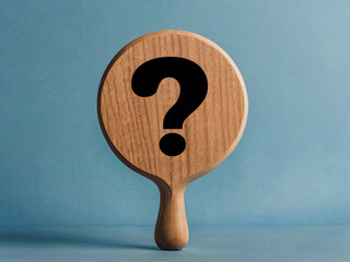Wooden question mark symbol on blue background query inquiry