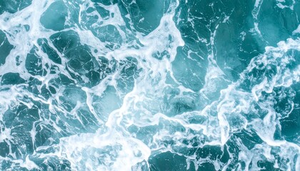 Obraz premium Aerial View of White Foamy Ocean Waves in Shades of Blue and Turquoise