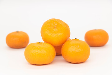 Citrus or tangerina and peeled fruit on white background