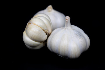 Fresh garlic isolated. Garlic bulbs with cloves on black background. White garlic bulb composition. With clipping path. Full depth of field.