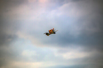 A small quadcopter flies in a cloudy sky with clouds