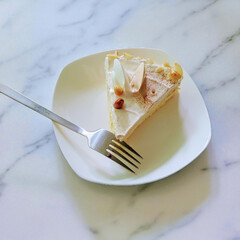Delicious Slice of Almond Cake on a White Plate with Fork