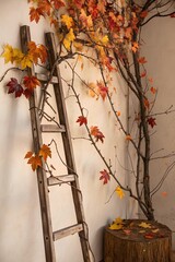 Decorative bamboo ladder entwined with natural autumn branches and leaves, placed beside tree stump, styled against soft yellow wall and green floor