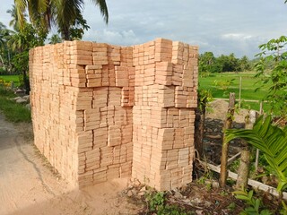 Red bricks neatly arranged on the side of the road