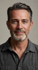 Obraz premium Professional studio portrait of a young adult man in a white shirt, looking at the camera with a slight smile. Clean background, soft lighting, perfect for business or lifestyle use.