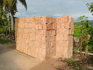 Red bricks neatly arranged on the side of the road