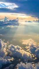 Aerial View of Sunlight Streaming Through Fluffy Clouds in a Tranquil Blue Sky