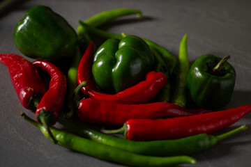 Collection of fresh green vegetables arranged on a textured gray surface